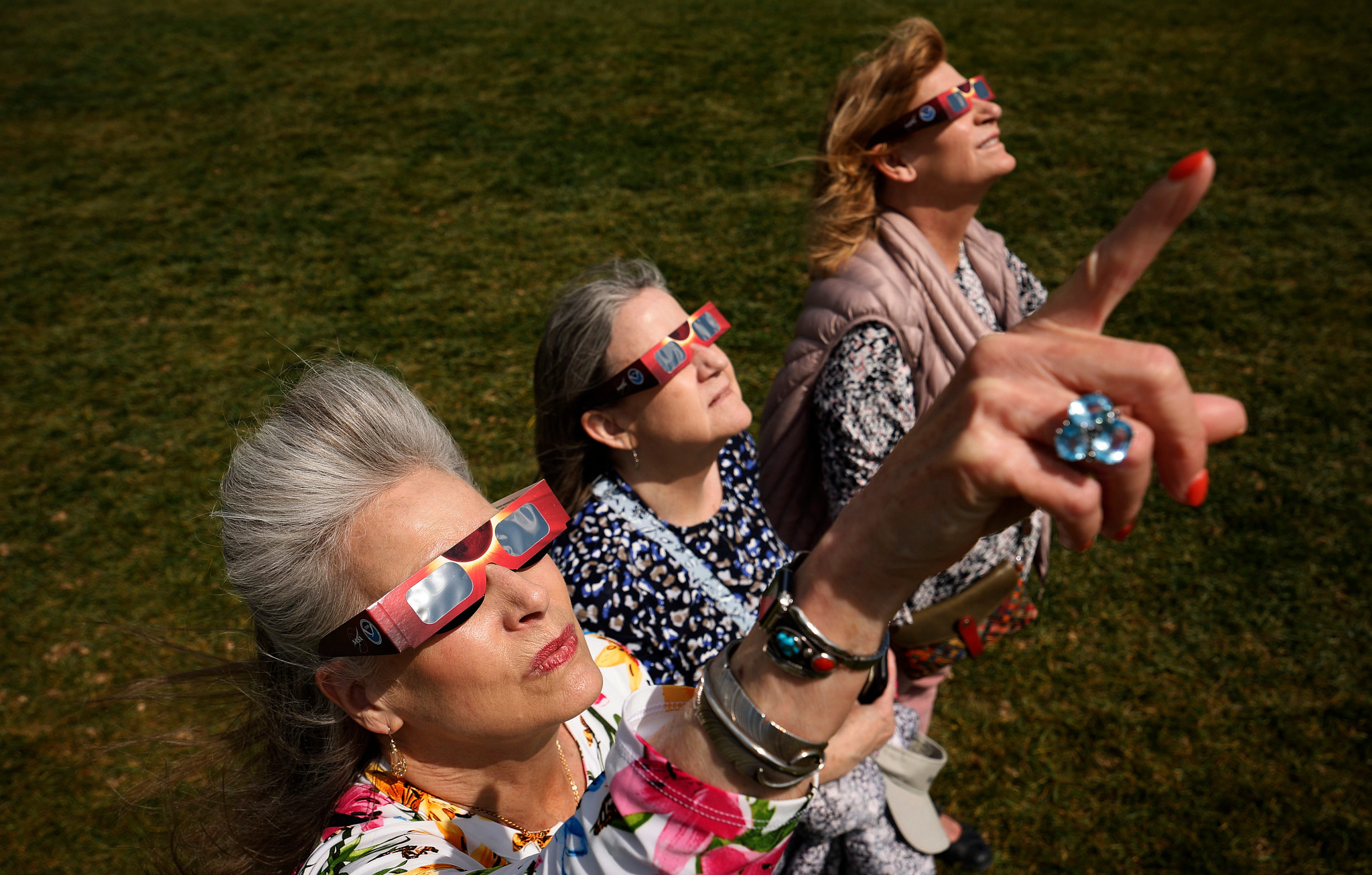 people wearing protective glasses while looking at a solar eclipse