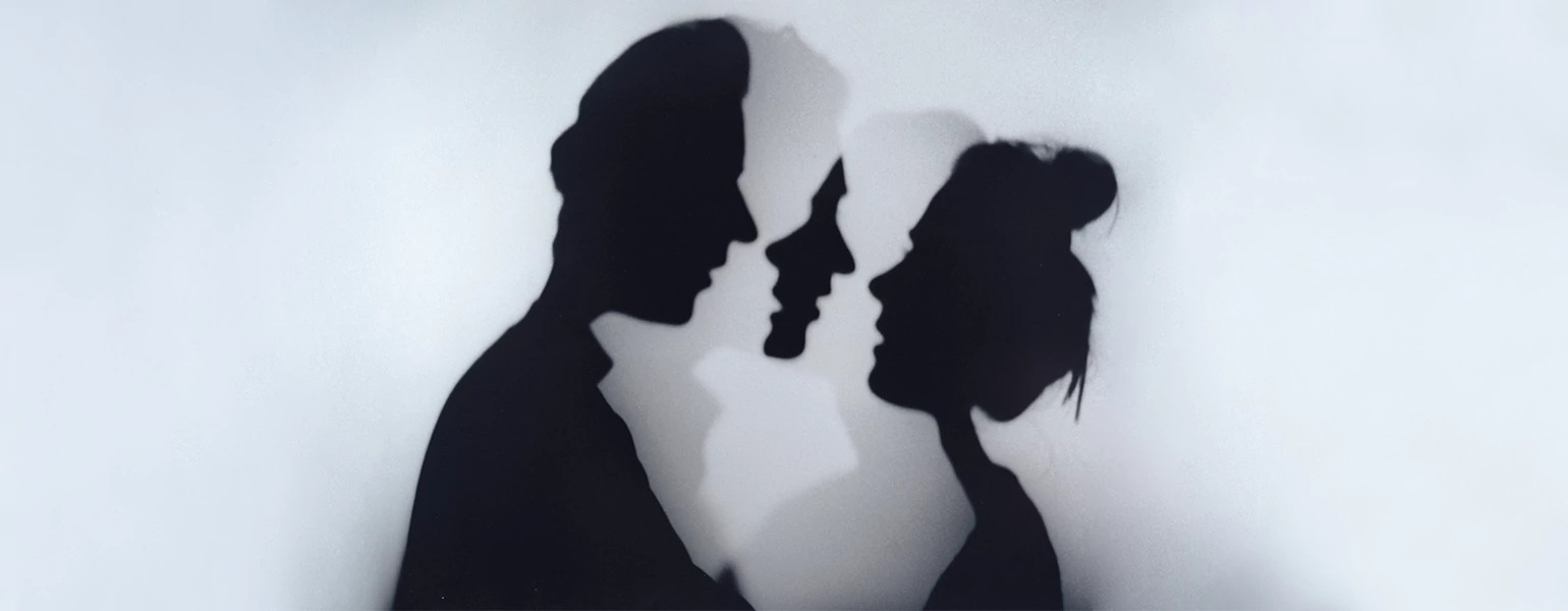 A photo of a woman and man standing face to face.