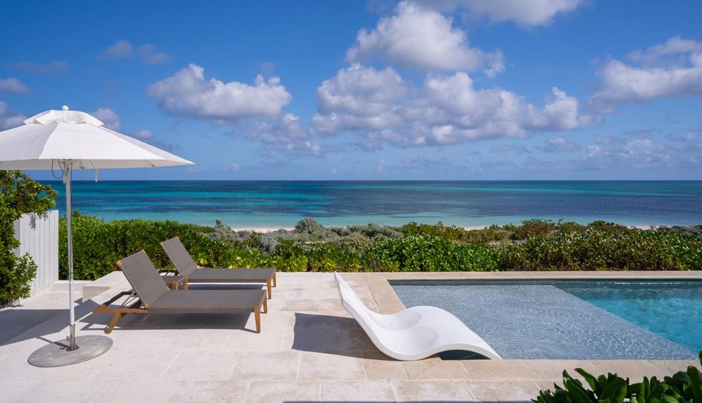 Multigenerational Trips a pool at a home overlooking the ocean
