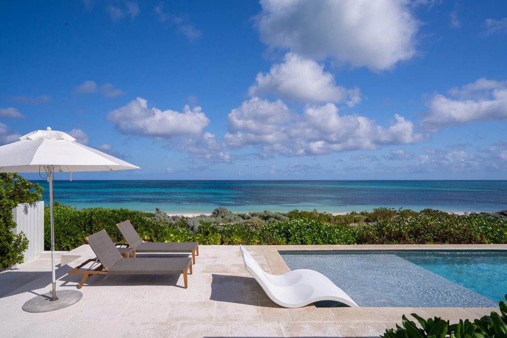 a pool at a home overlooking the ocean