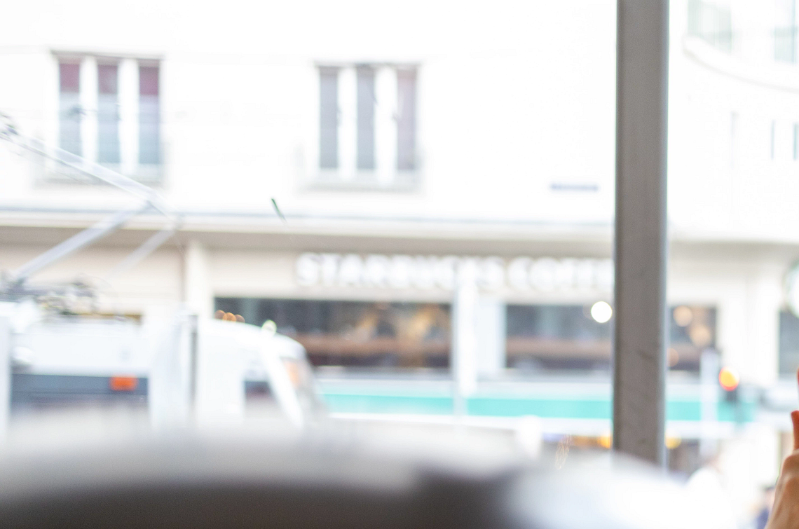 Reducing notifications on your phone a woman is looking at her smartphone while sitting at a table with her laptop