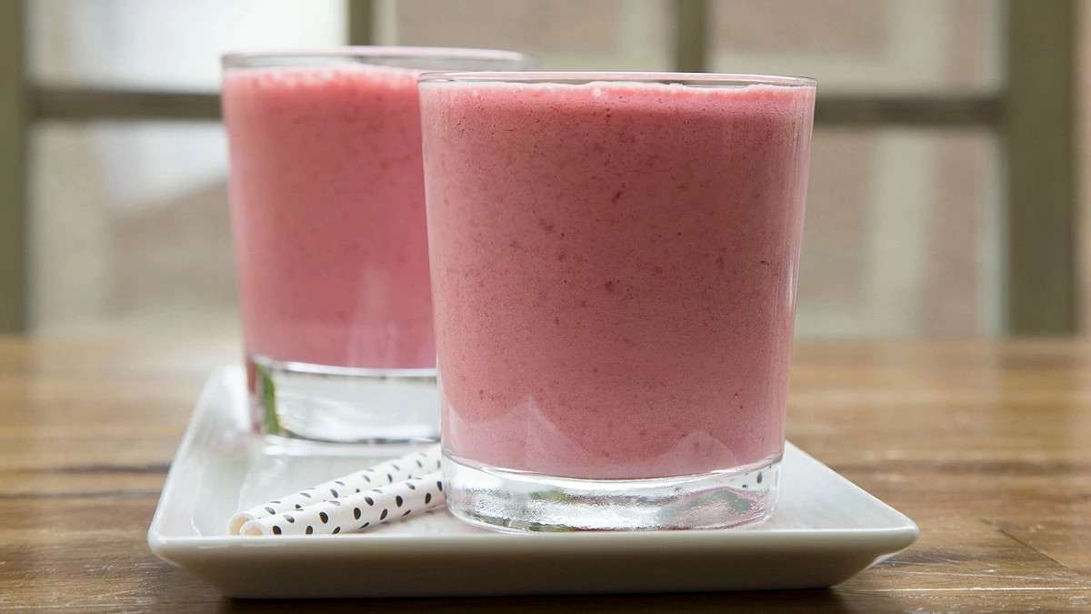 A close-up view of strawberry-almond smoothie in two glasses