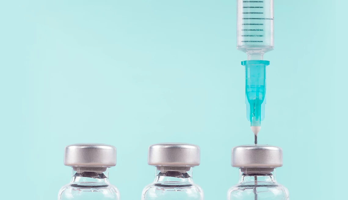 syringe and vaccine bottles
