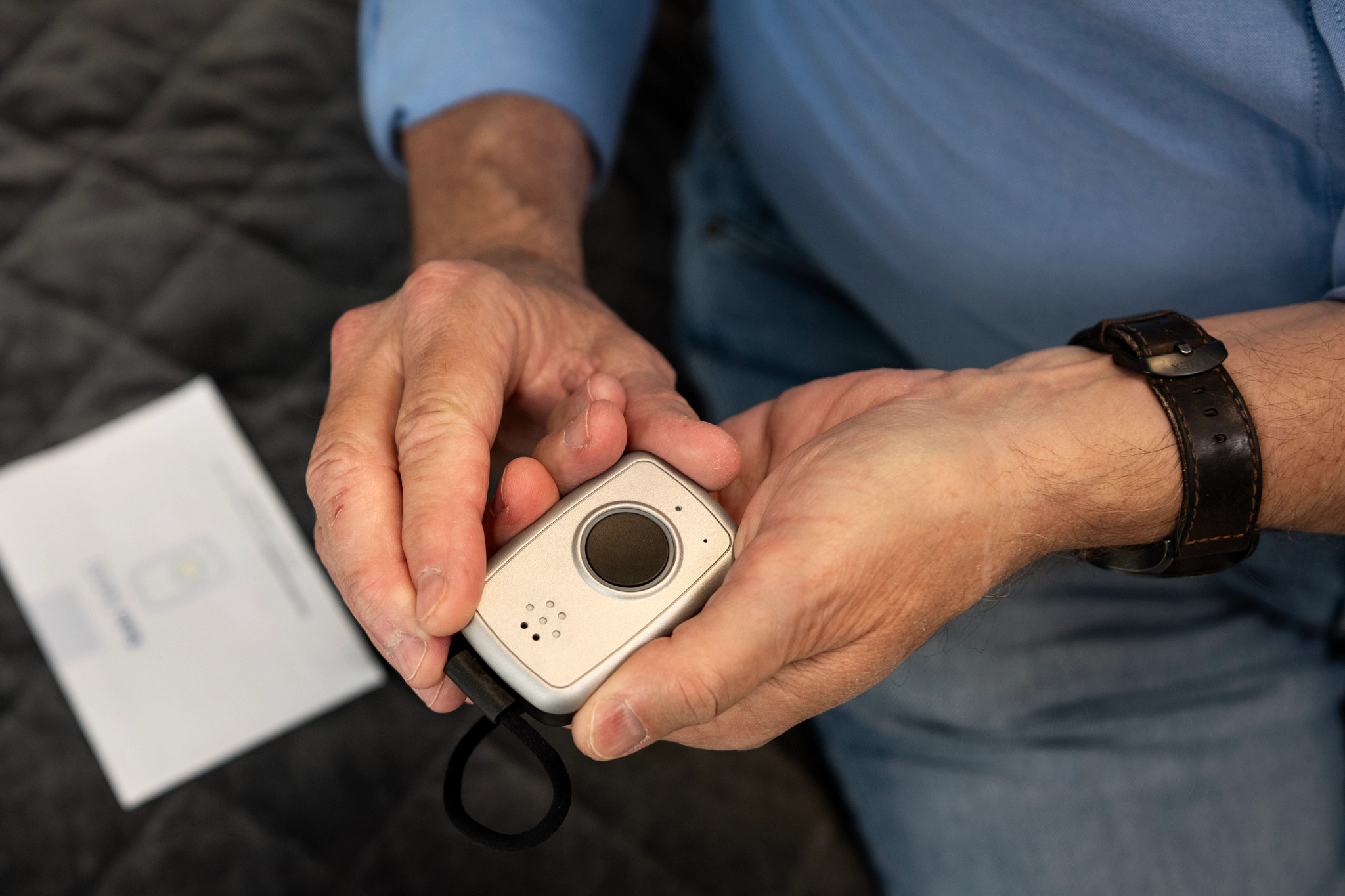 A man holding the MobileHelp Solo pendant