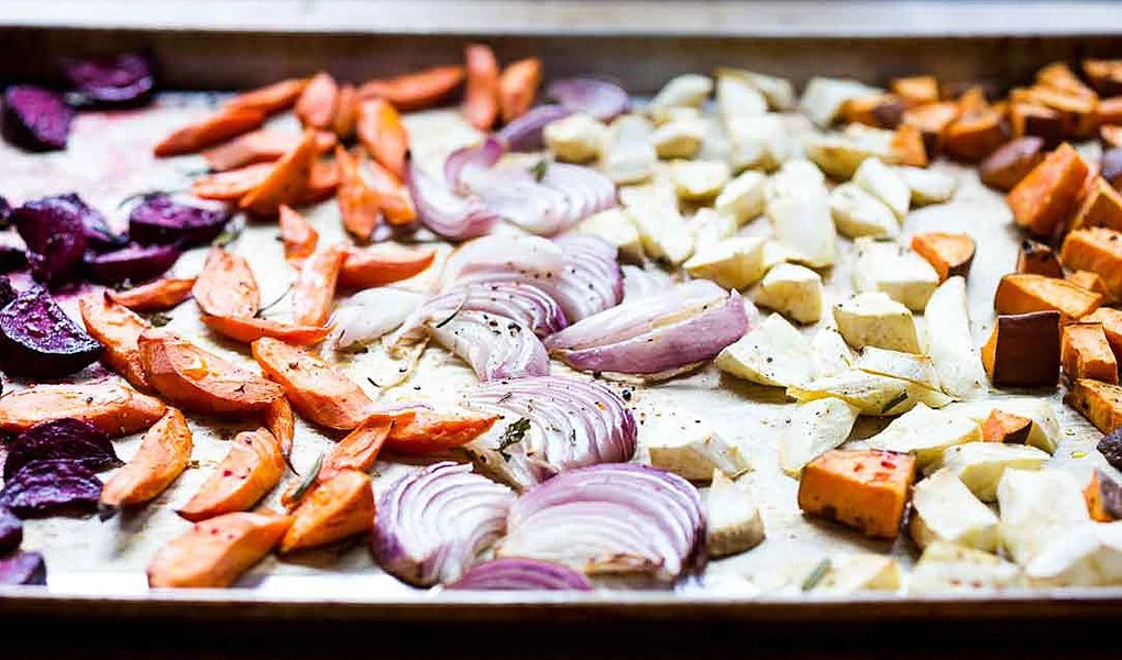 A close-up view of roasted root vegetables on a sheet pan
