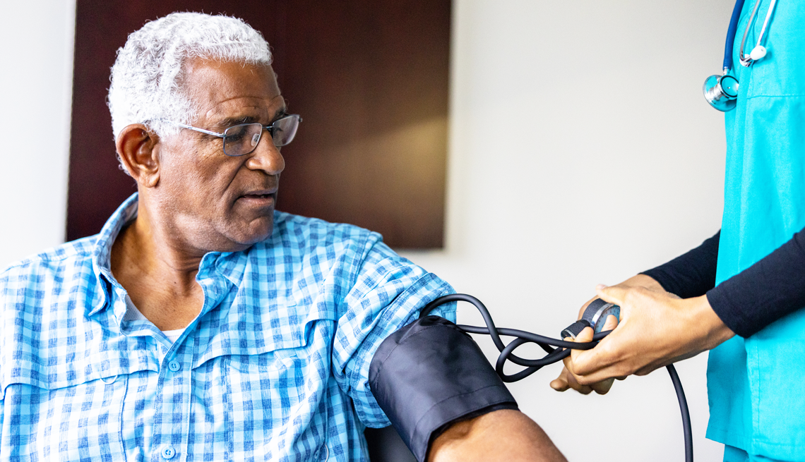 Understanding high blood pressure. a man getting his blood pressure checked at the doctor's office