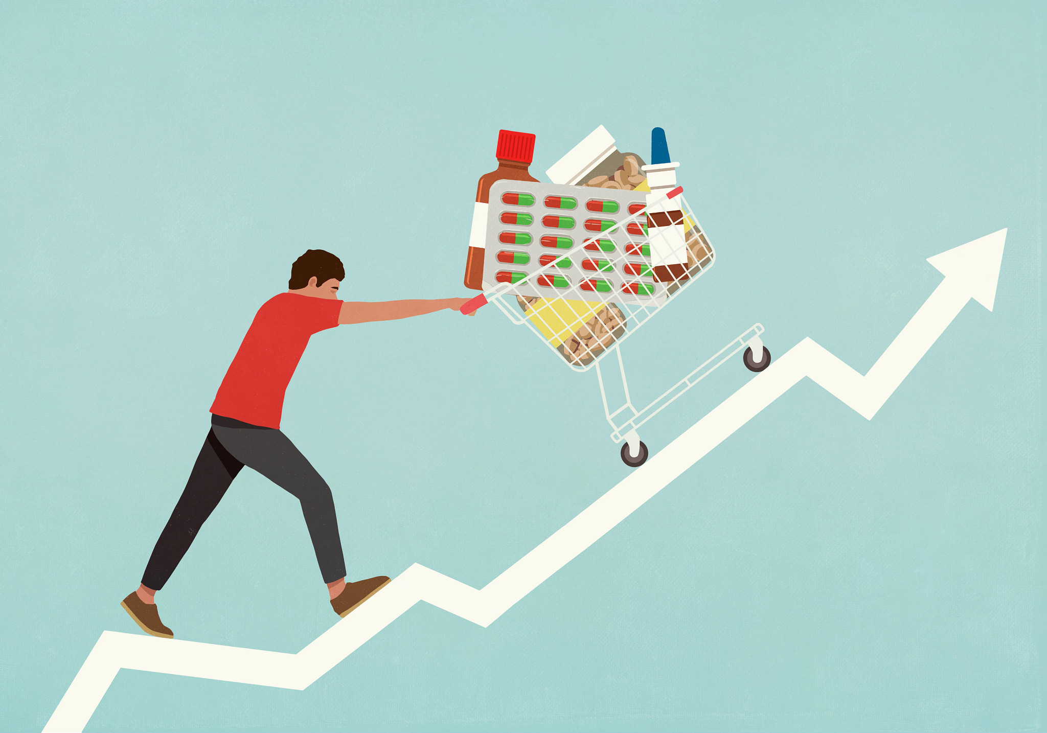 An illustration of a person walking up a steep, rising white arrow that resembles a stock market chart. The person is straining as they push a shopping cart overflowing with various large medications, including pill blister packs, a medicine bottle, and a nasal spray.