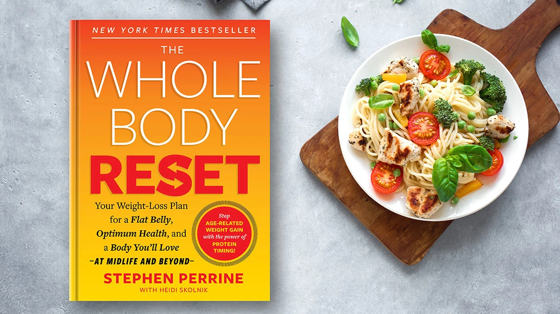 whole body reset book on gray table with salad in white bowl on wood cutting board