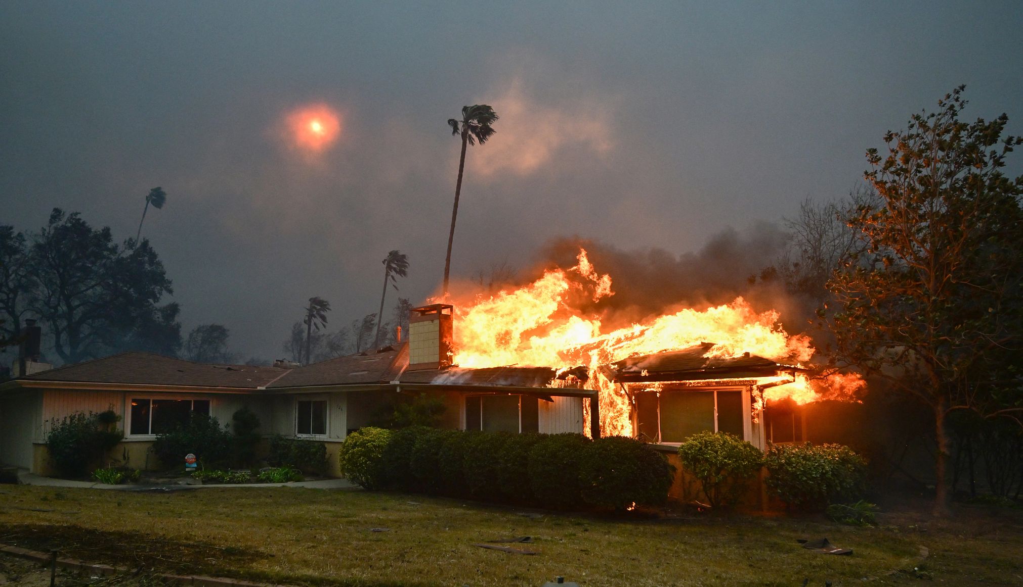 Scammers exploiting wildfires A home burns