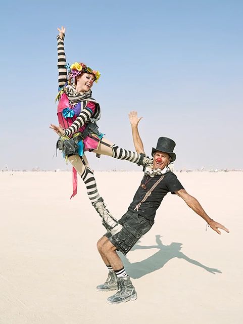 Burning Man for Older Adults a woman standing on a man while posing