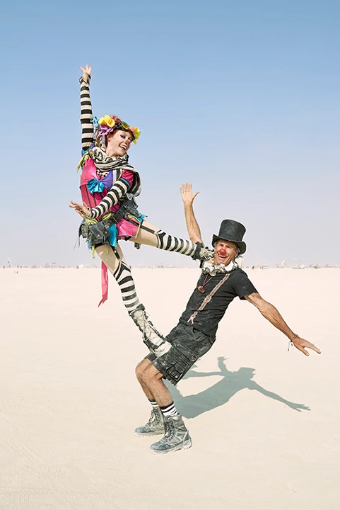 a woman standing on a man while posing