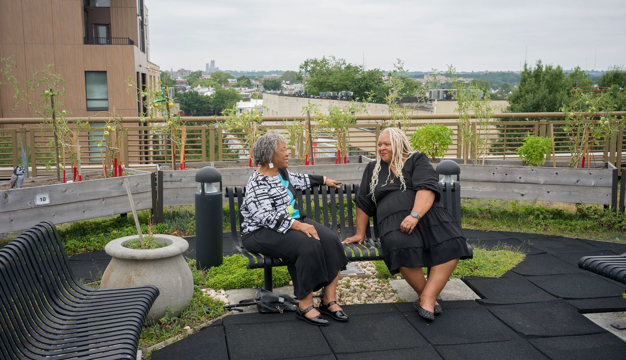 Friendship Bench Program Offers Mental Health Support A photo shows grandparent Angela Jasper (on the left) offering a sympathetic ear (with no judgment) to visitor Robin Baxter on a Friendship Bench on the roof of the Bernice Fonteneau Senior Wellness Center in Washington, D.C.