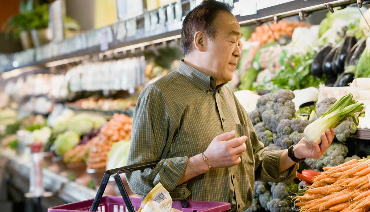 Man in produce aisle at grocery store