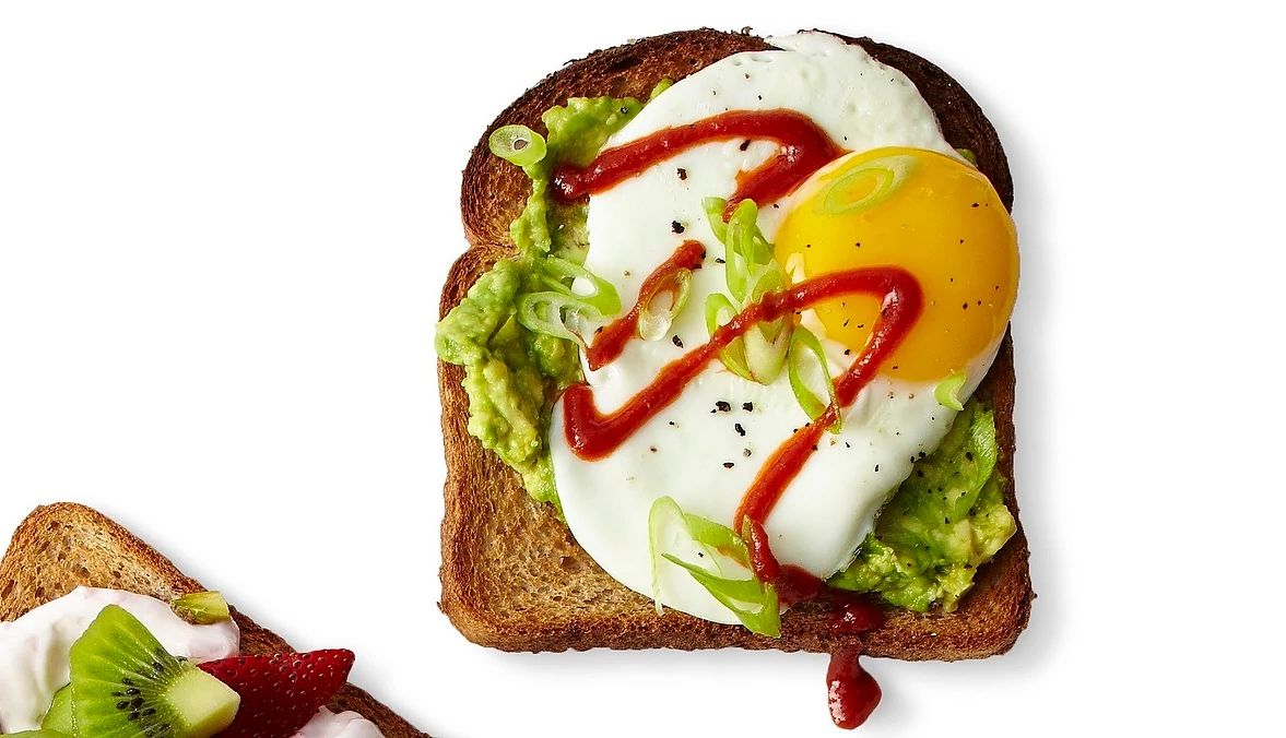 Avocado-egg toast An overhead view of avocado-egg toast on a white background