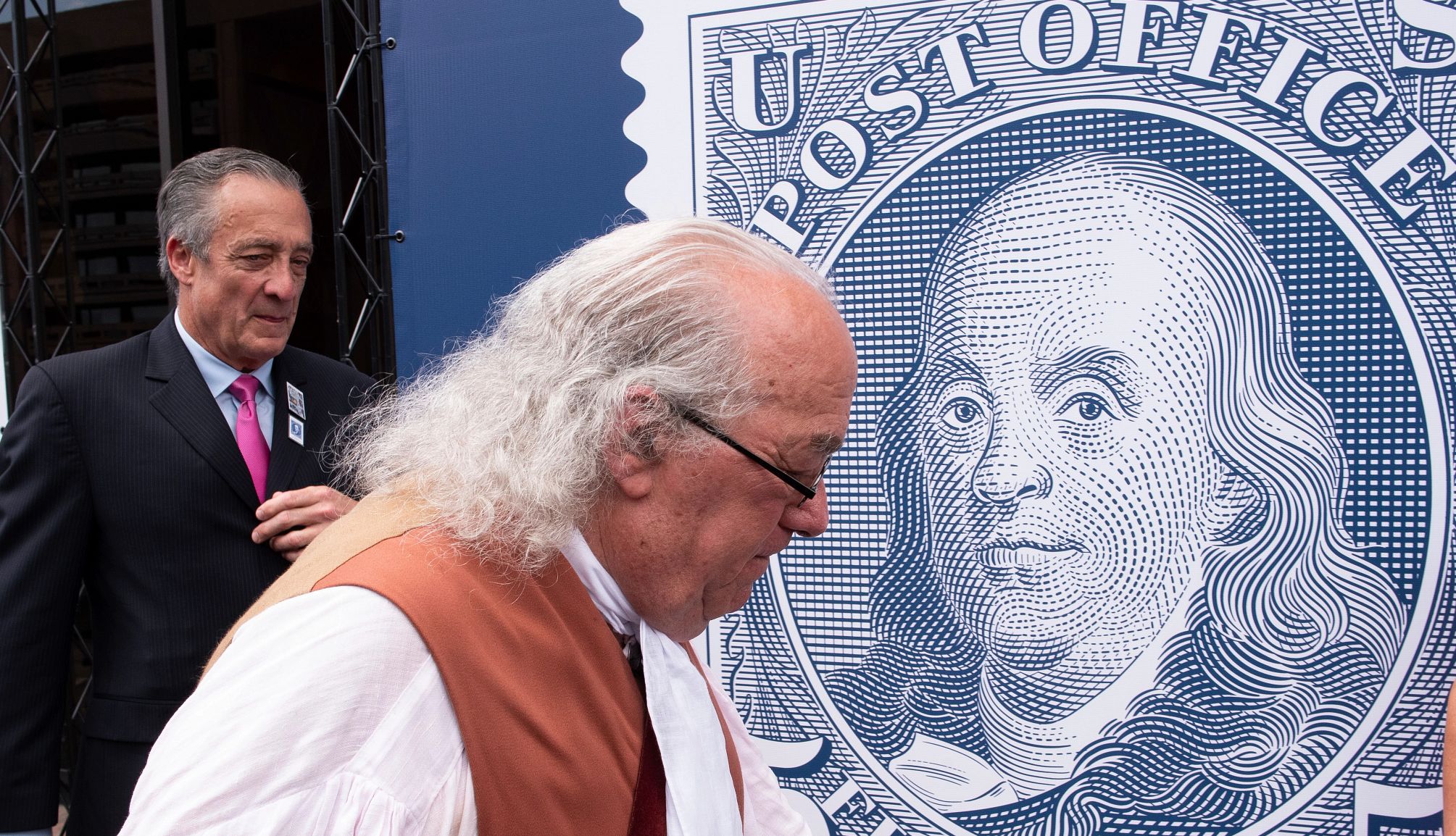 How the Post Office Put Its Stamp On the Nation a person dressed as ben franklin looking at a ben franklin stamp