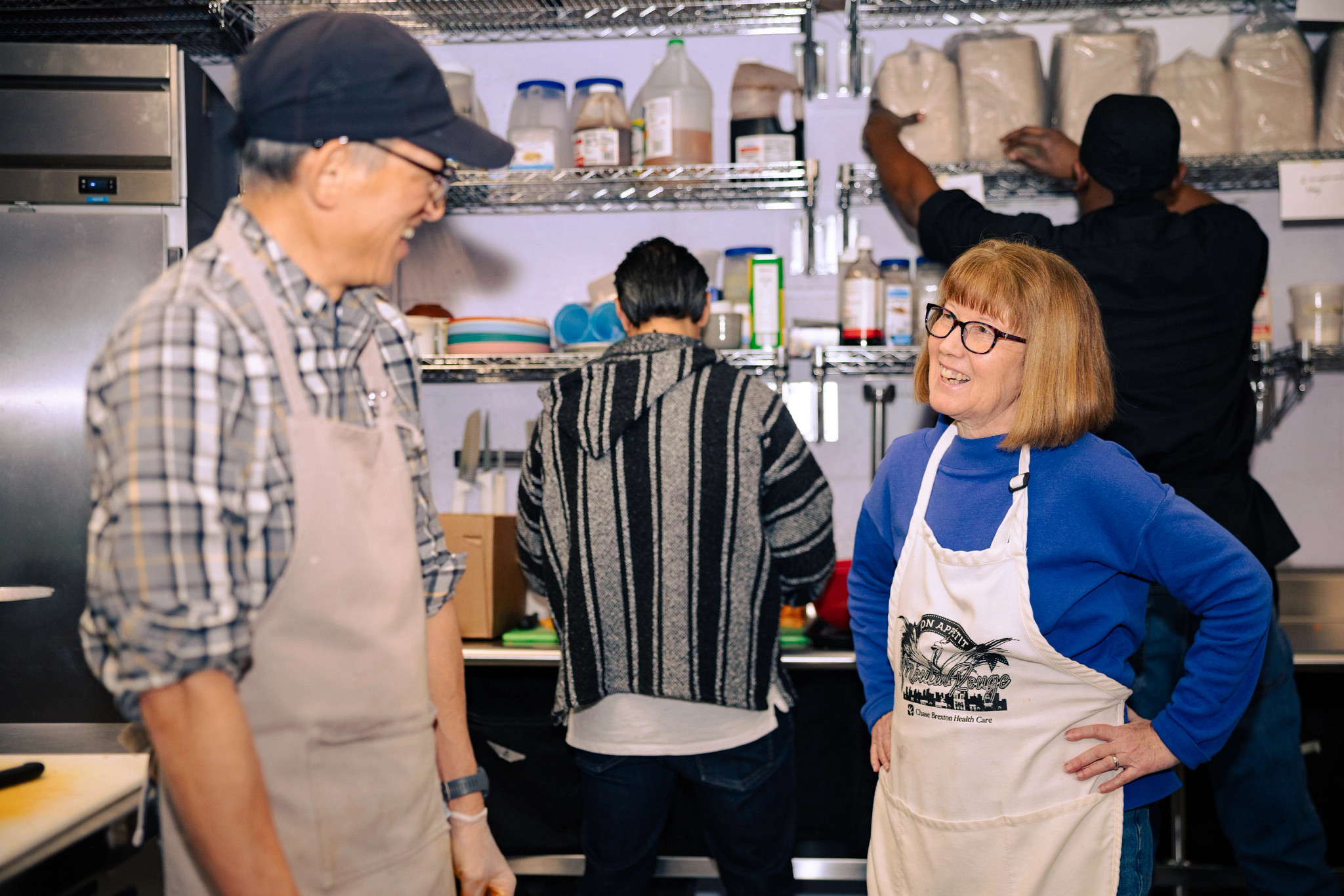Volunteers and staff prepare the day’s fresh meals