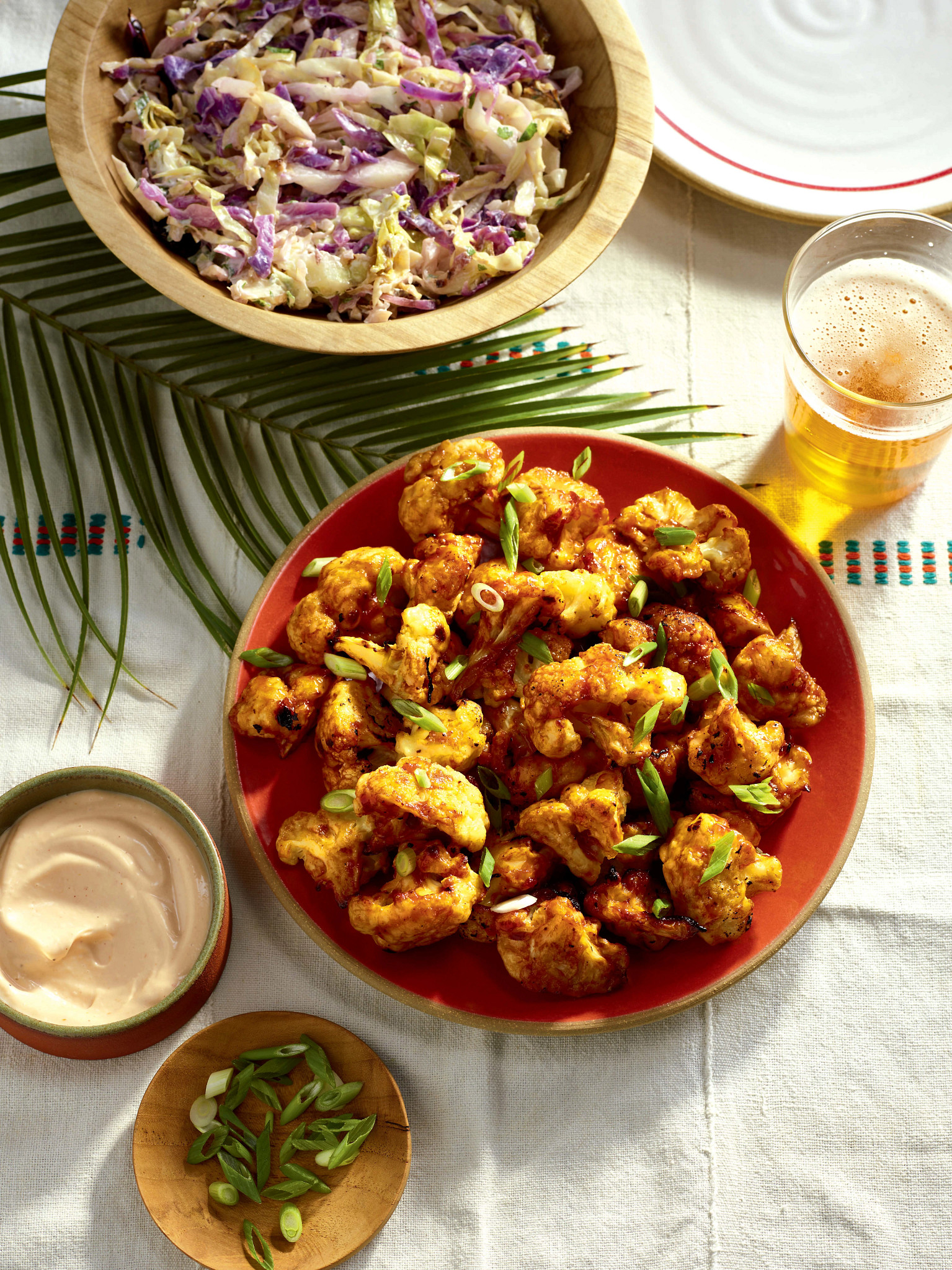 a photo shows anthony anderson and cedric the entertainer’s korean hot cauliflower wings 