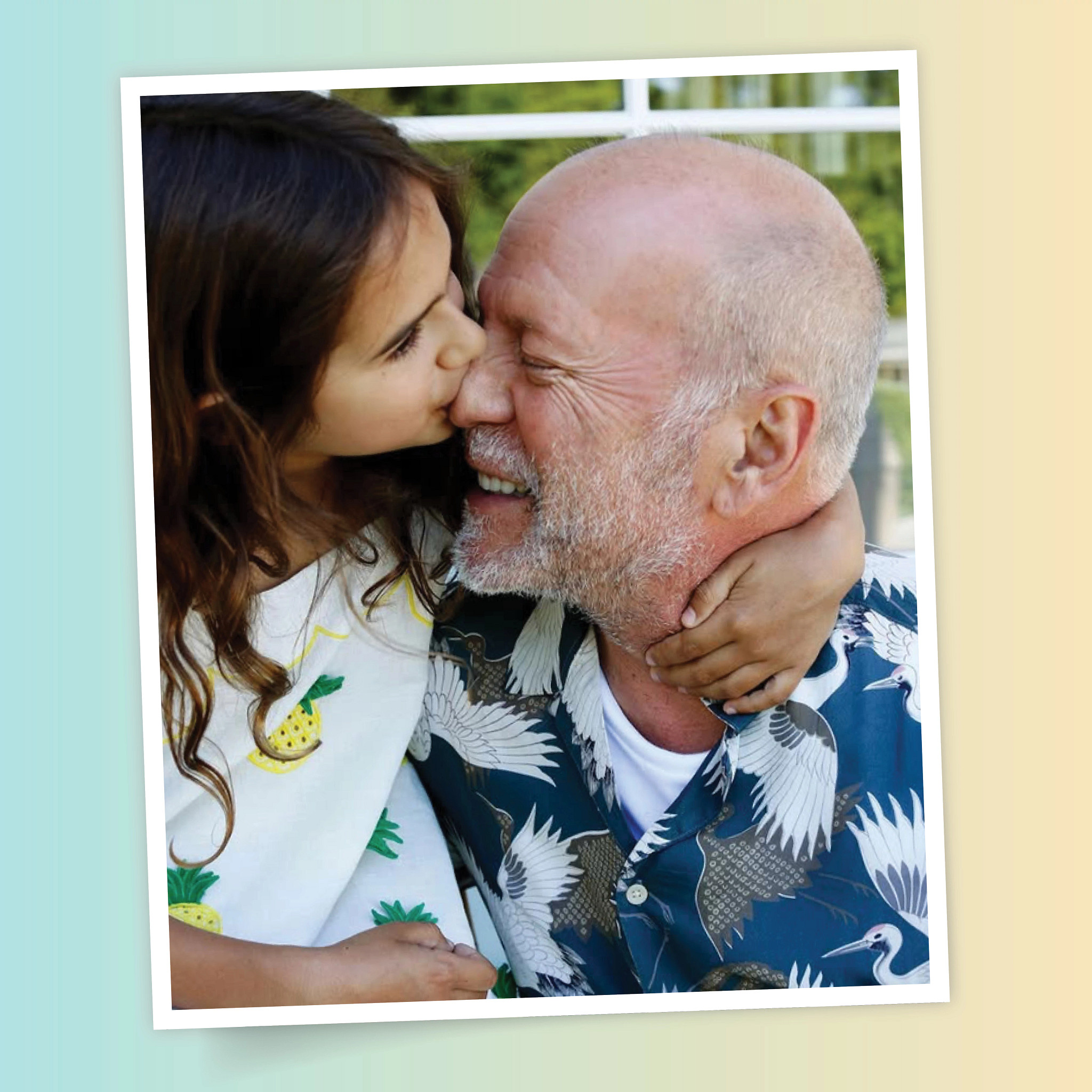 a man getting kissed on his nose by a child