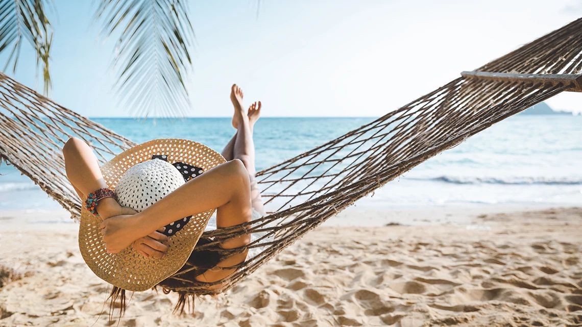 Woman laying on a hammock.