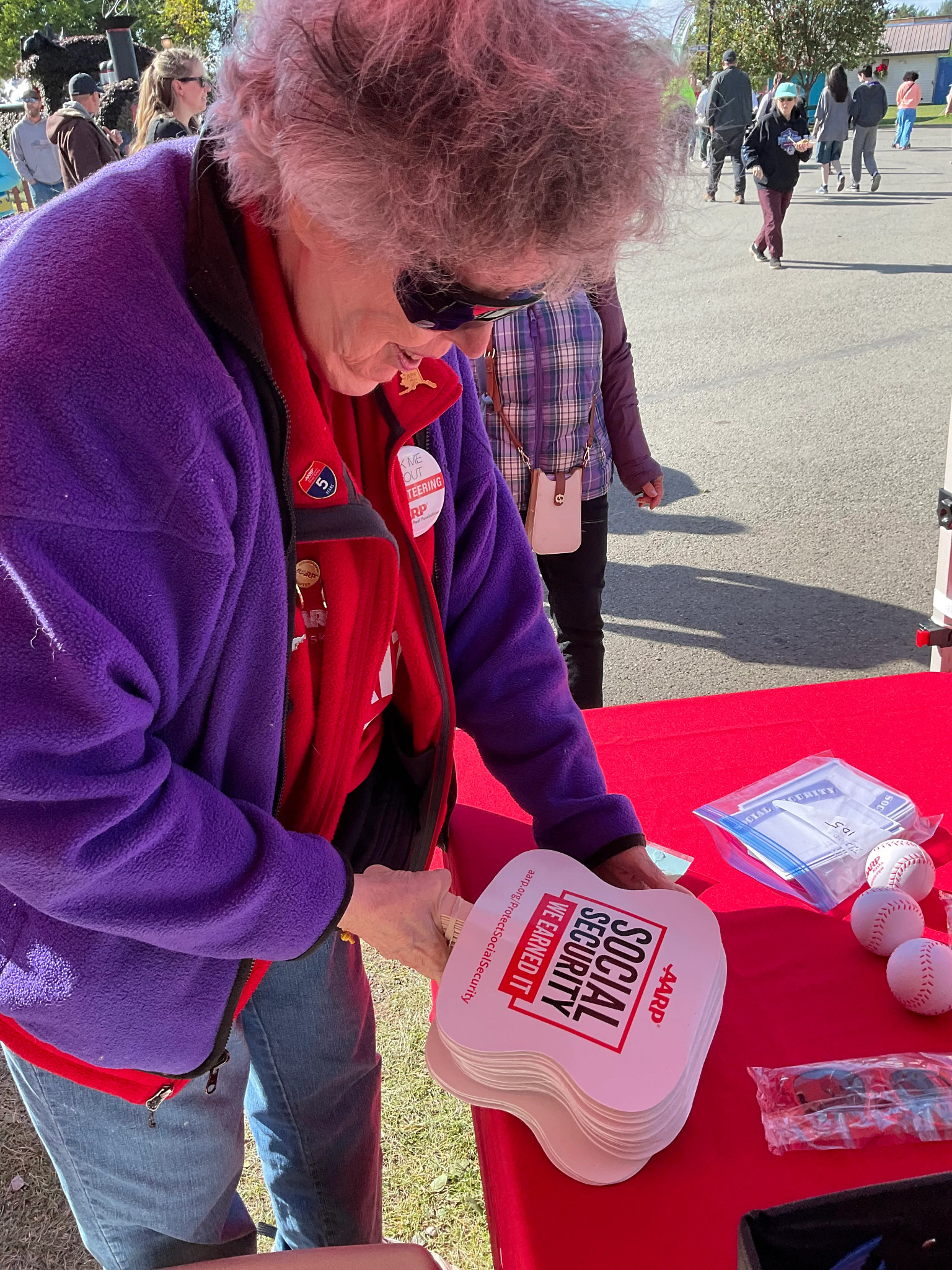 Volunteer Trish prepares materials for that 90th Anniversary of Social Security at the Alaska State Fair