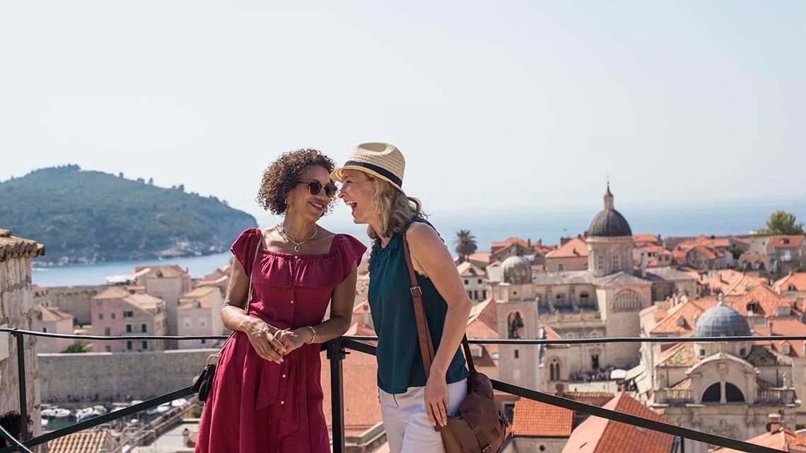 Two women laughing while sightseeing in Portugal