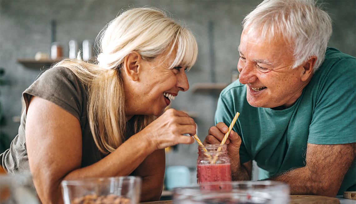 The beverages you choose can affect how you think, feel and function A man and woman drinking a smoothie together in a kitchen