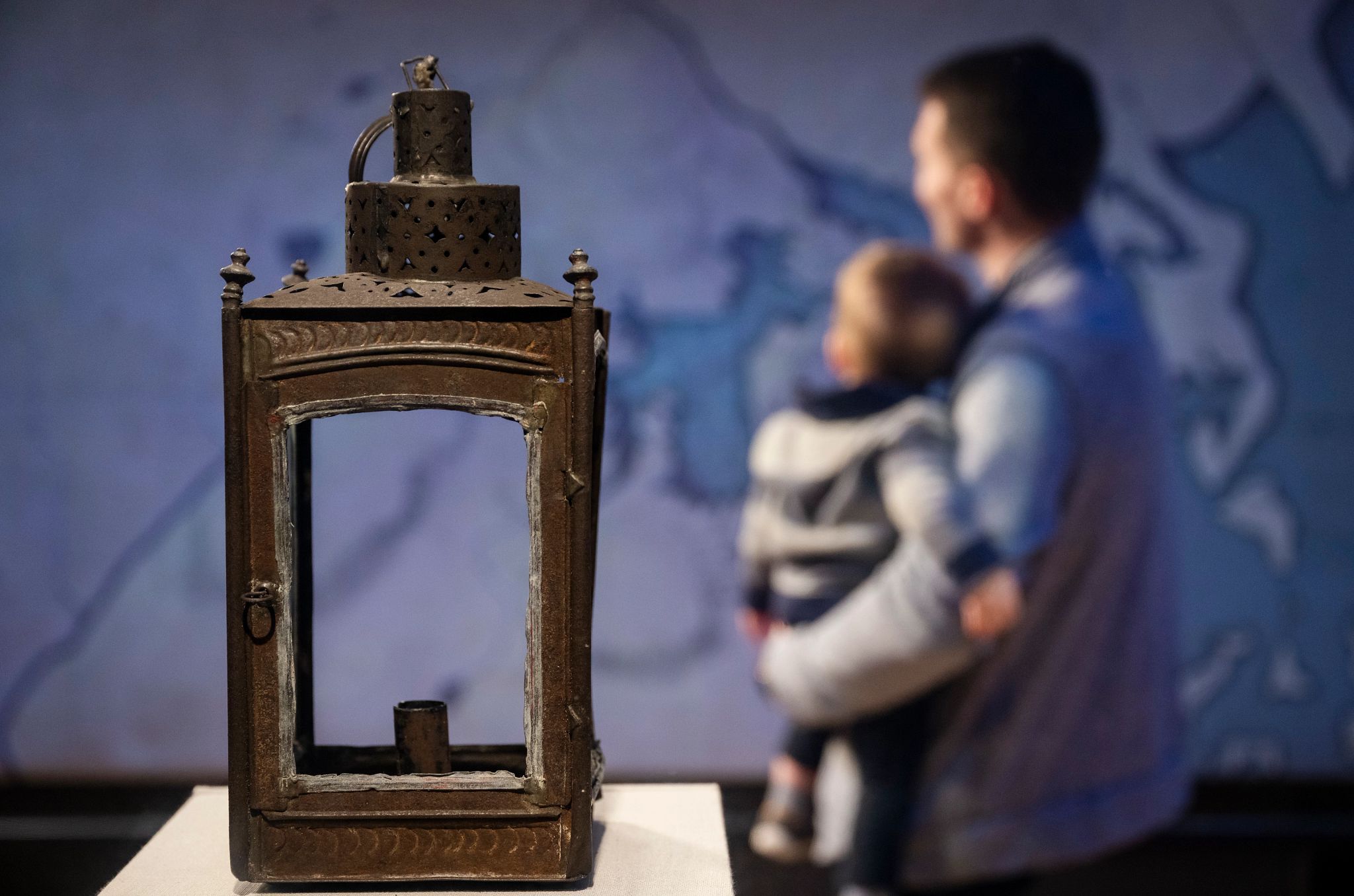Concord Museum a lantern sits in the foreground with a father and child in the background
