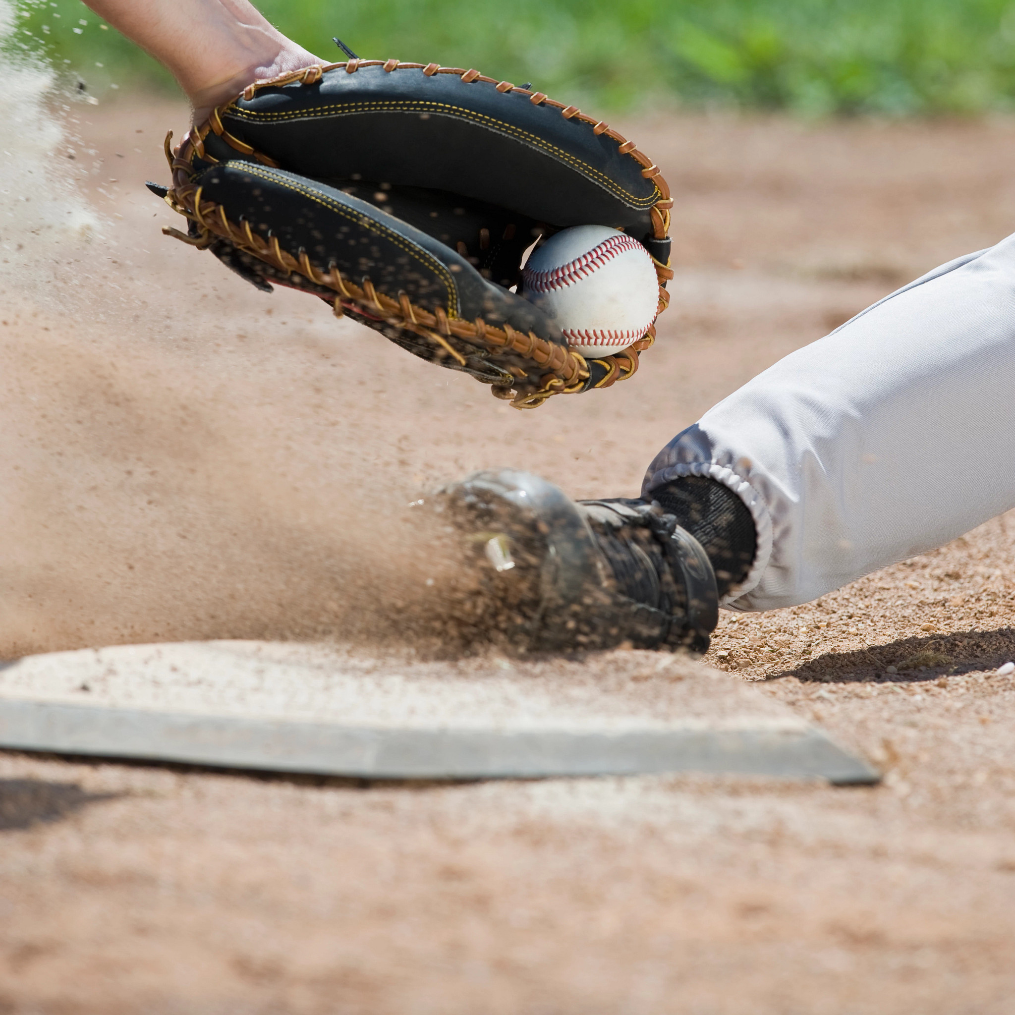 Close up of baseball player sliding into home plate
