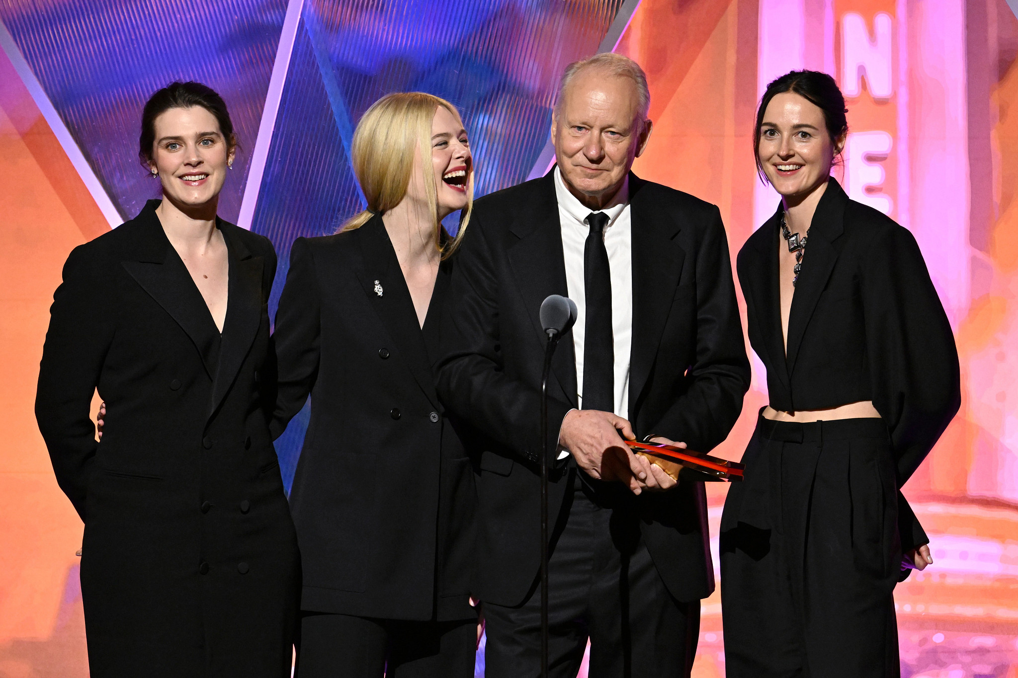 Inga Ibsdotter Lilleaas, Elle Fanning, Stellan Skarsgård, and Renate Reinsve accepting an award onstage