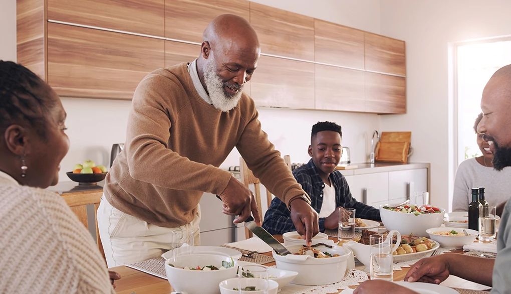 Eating in a calm and mindful state can help ward off your brain's stress signals A family eating a meal together in a home