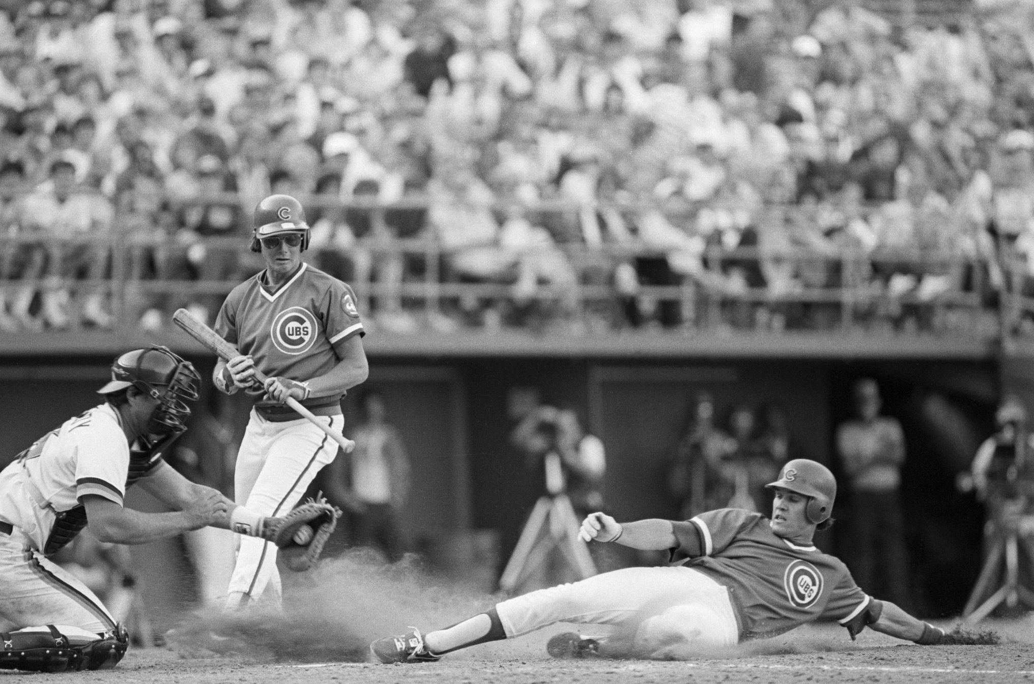 Ryne Sandberg, Hall of Fame Baseball Player, Dies at 65 ryan sandberg slides into home plate as two other players look on