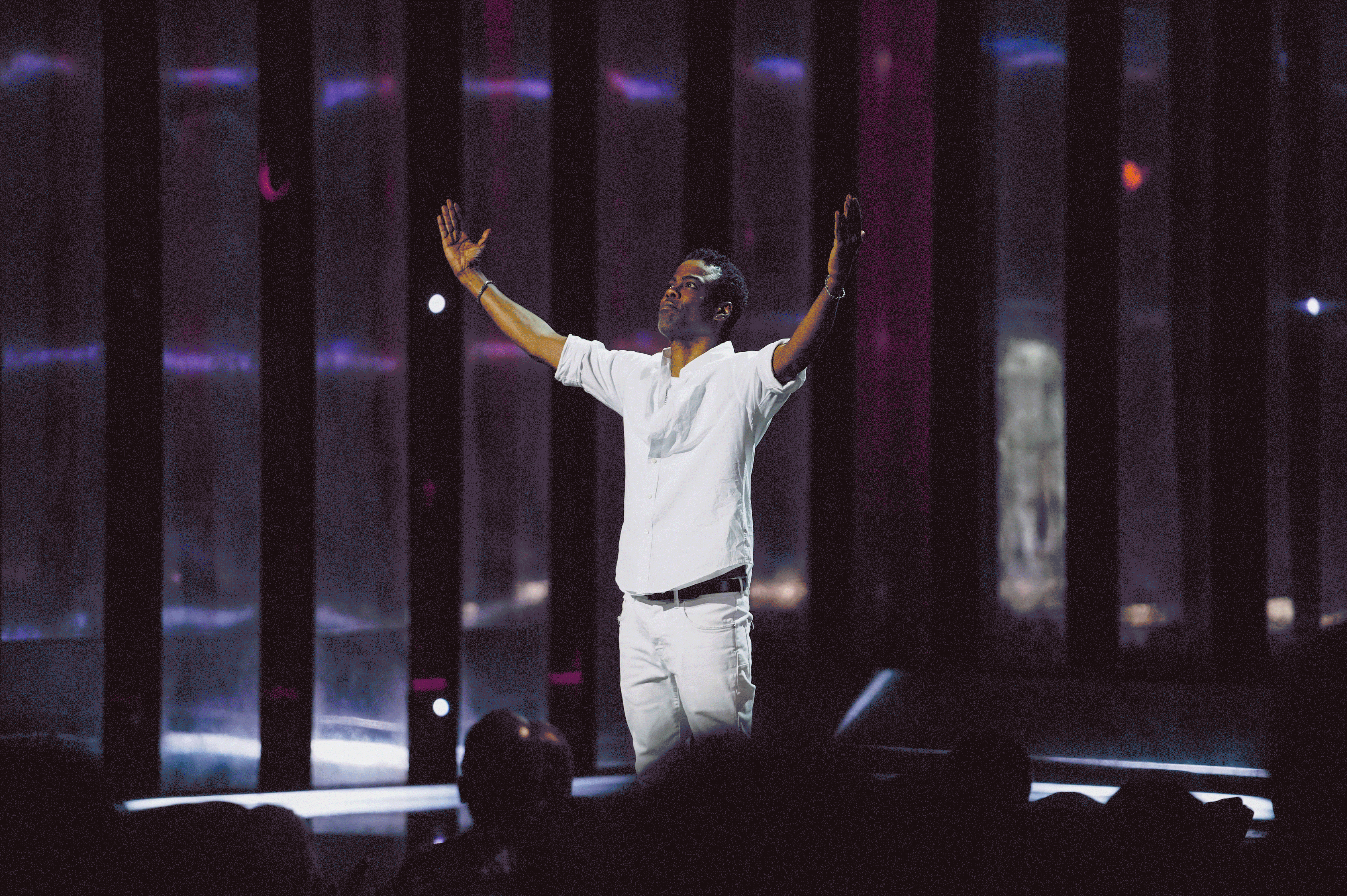 an animated gif switching between still images from standup comedy specials by chris rock, ali wong, patton oswalt, michelle wolf and john mulaney