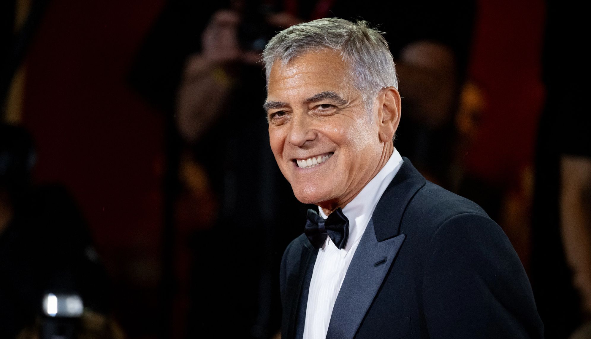 George Clooney’s Priorities Have Changed george clooney smiling while wearing a black tuxedo