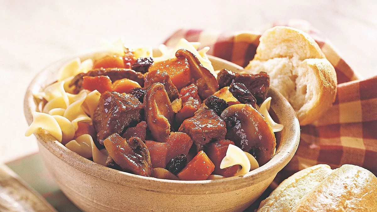 A close-up view of beef-mushroom stew in a bowl