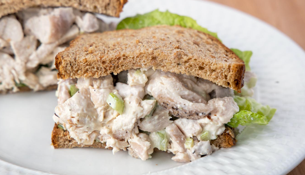 Chef Dennis Littley's Best Chicken Salad Chicken salad between two slices of bread on plate