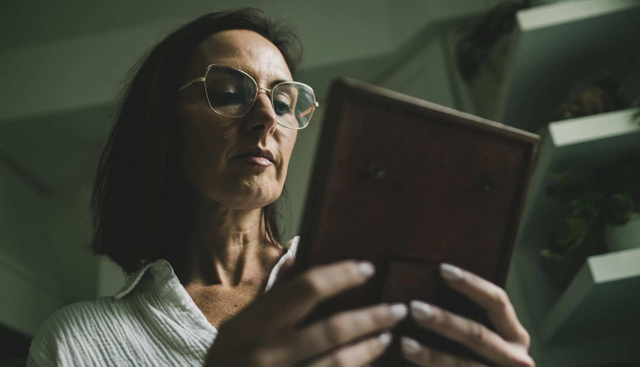 Letting Go of Perfect: Lessons on Family Caregiving Jeanette Yates viewing a portrait of her mother