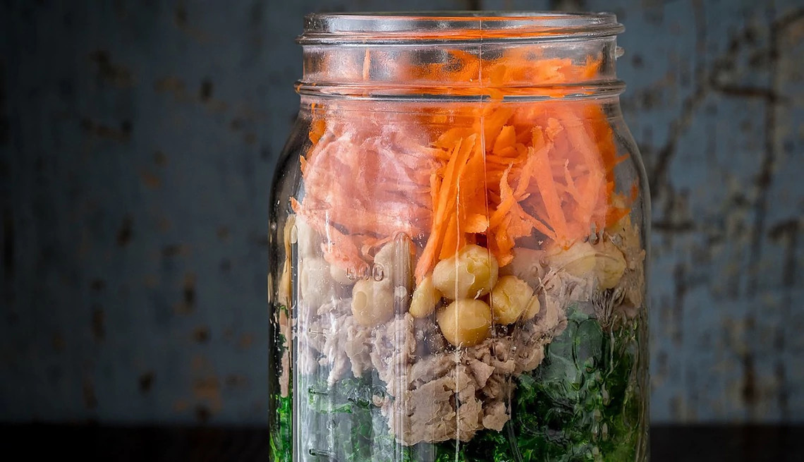 A close-up view of a mason jar power salad with chickpeas and tuna