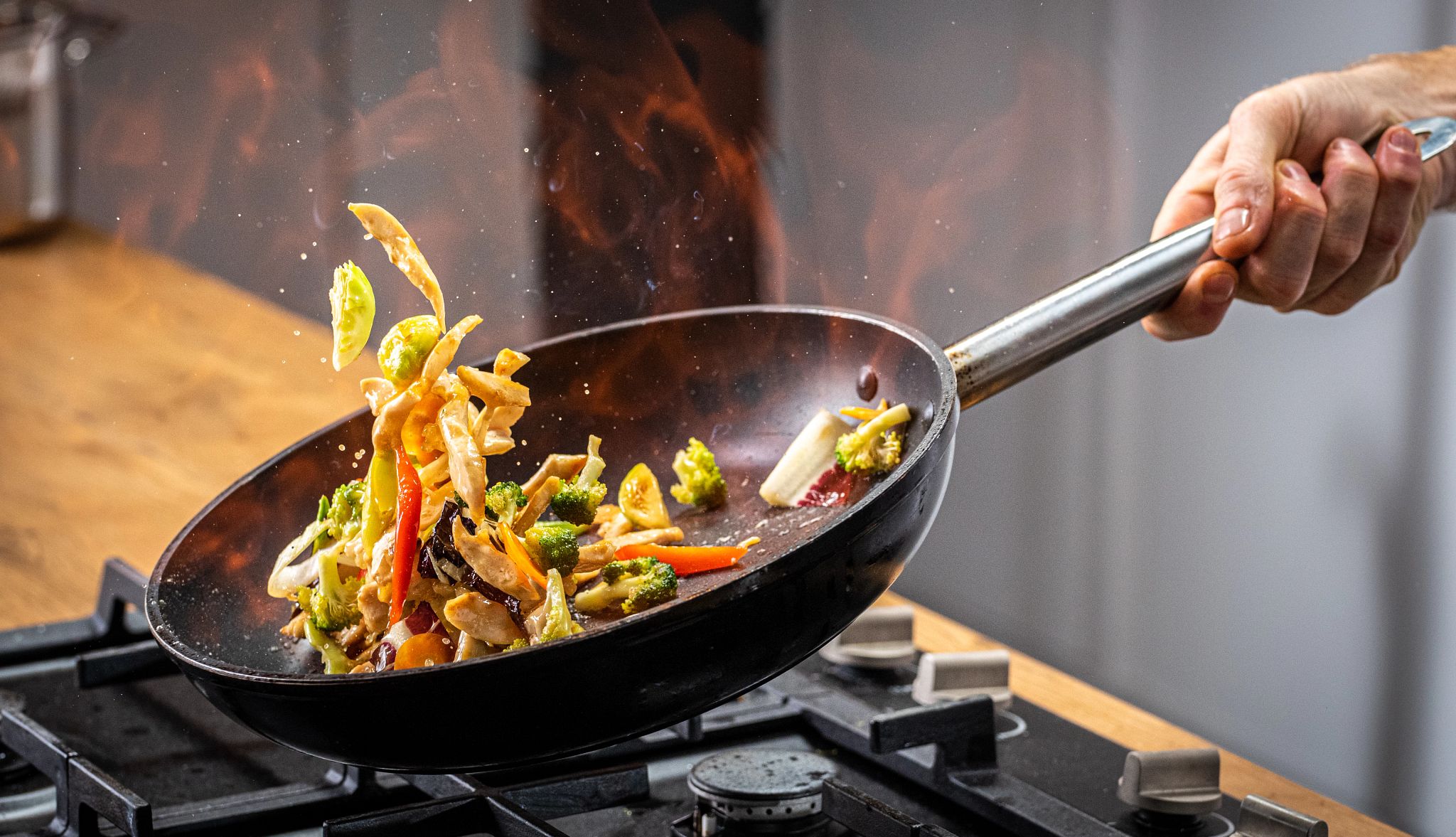 Close up shot of a chef sauteing vegetables Close up shot of a chef sauteing vegetables