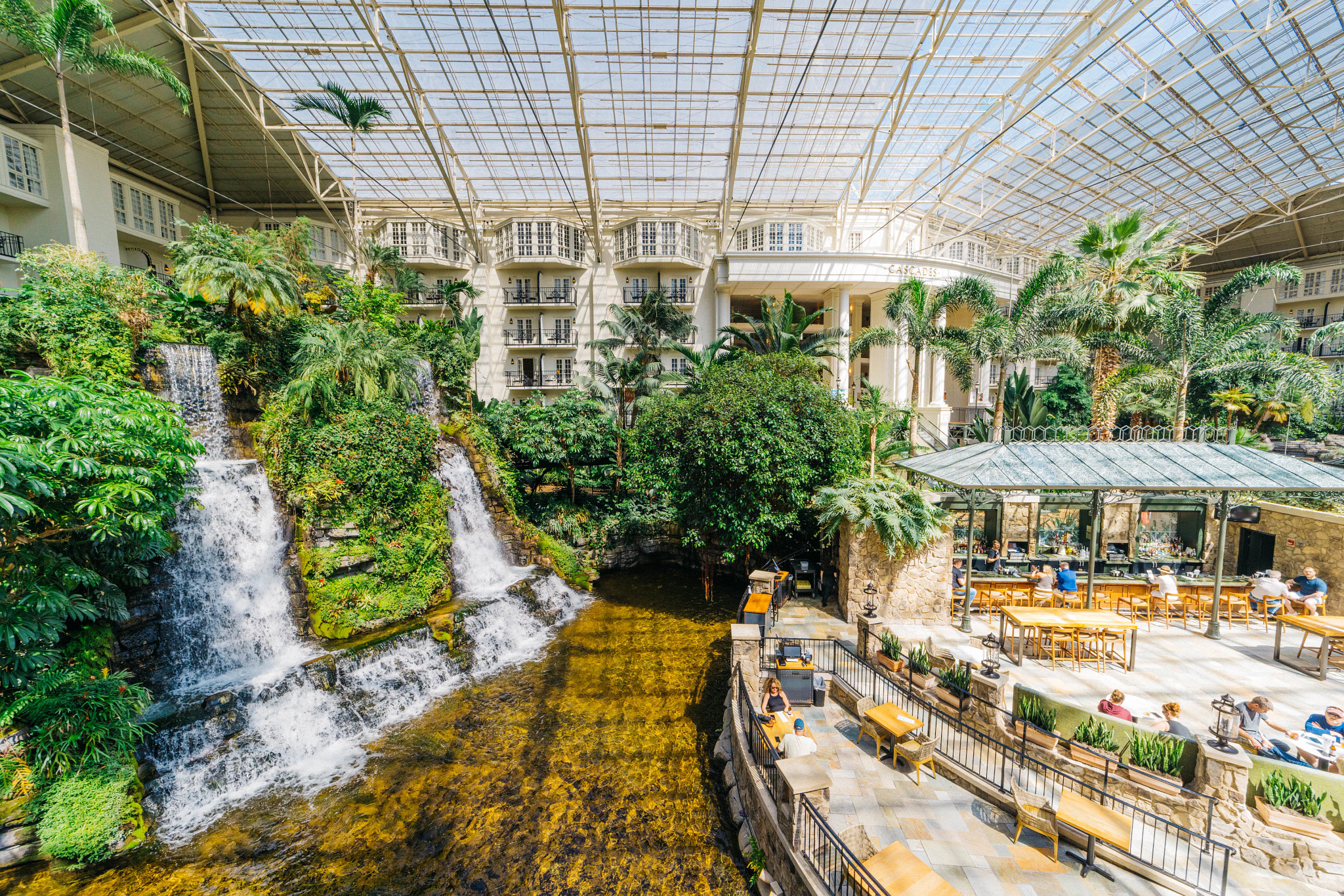 an indoor waterfall next to a restaurant