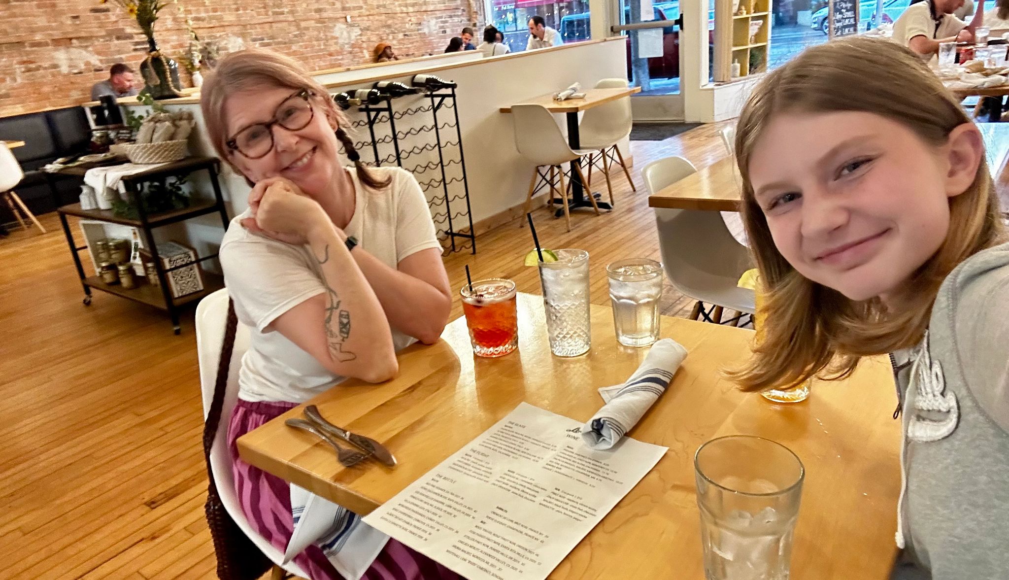 Thrift Road Trip a mom and daughter smiling while sitting in a restaurant