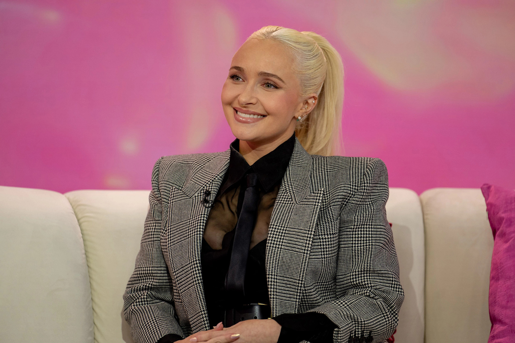Hayden Panettiere smiling on a talk show set