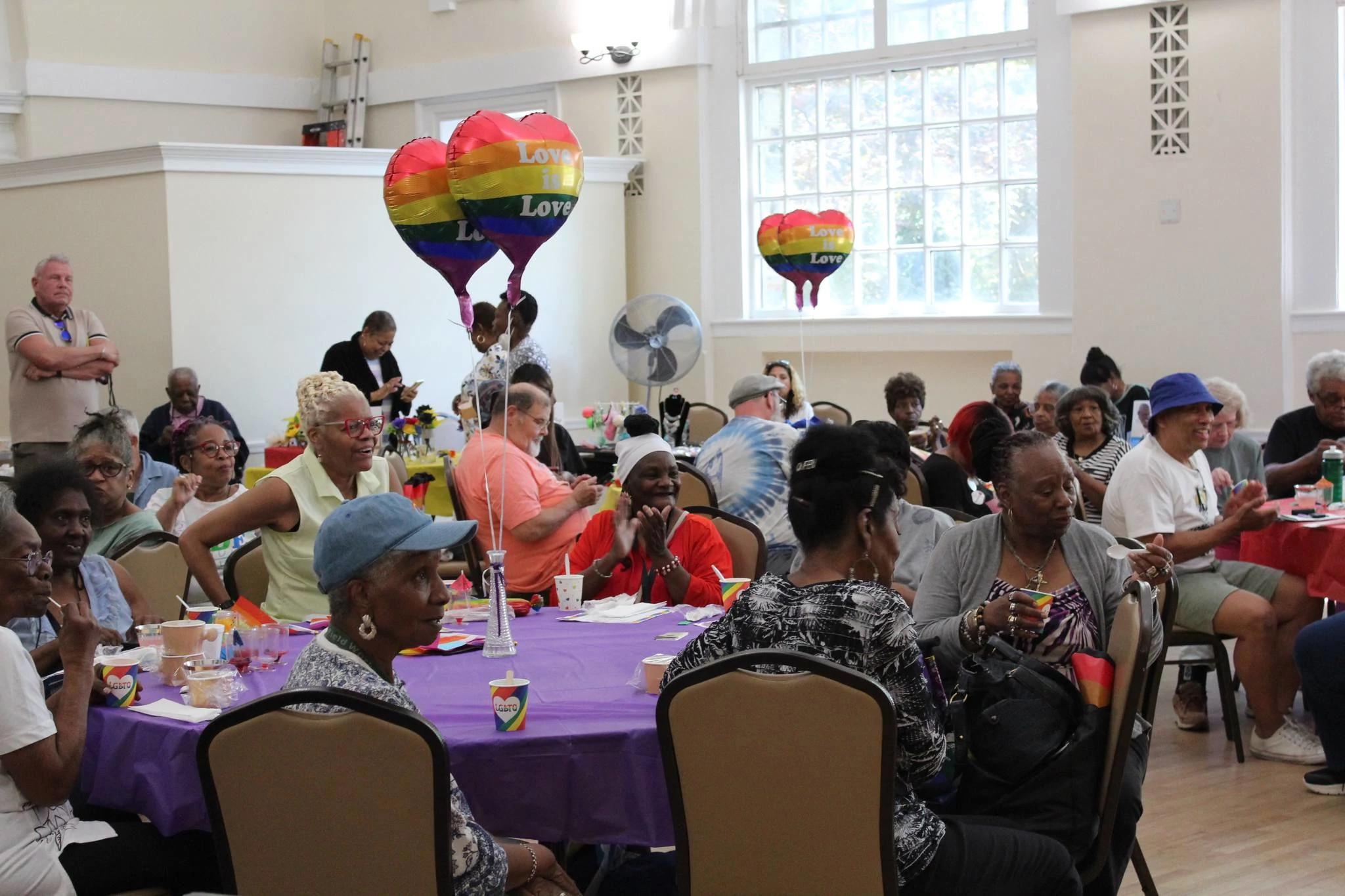 a group of people sitting at tables during a celebration