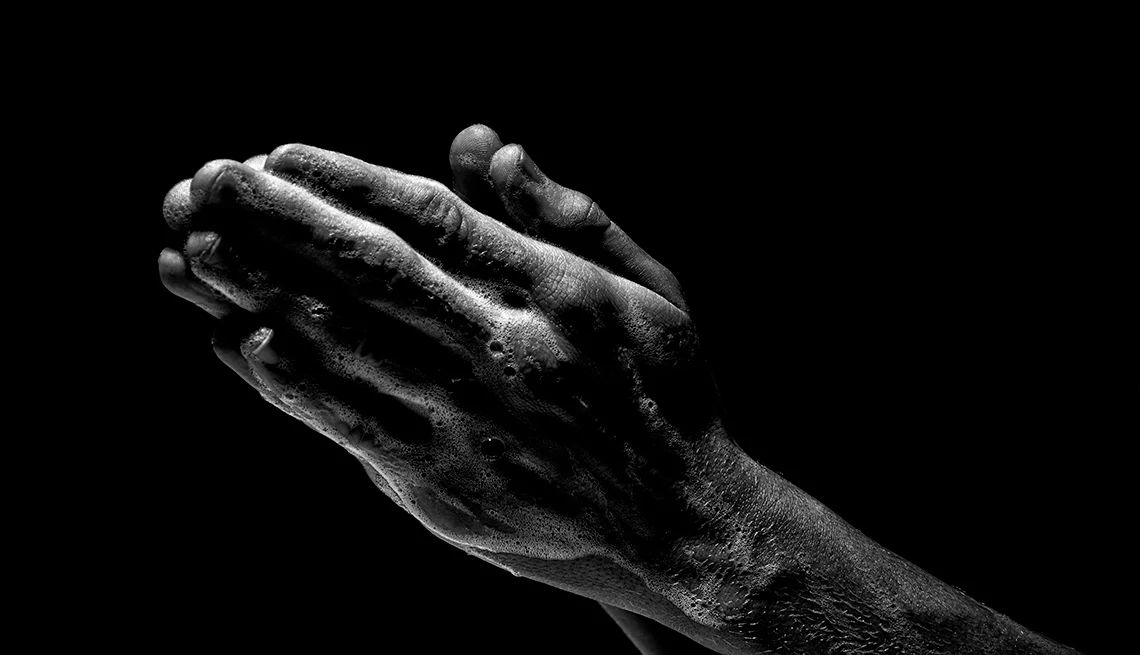 Faith leaders may be able to provide support on brain health A close-up view of a set of hands touching in prayer with a black background