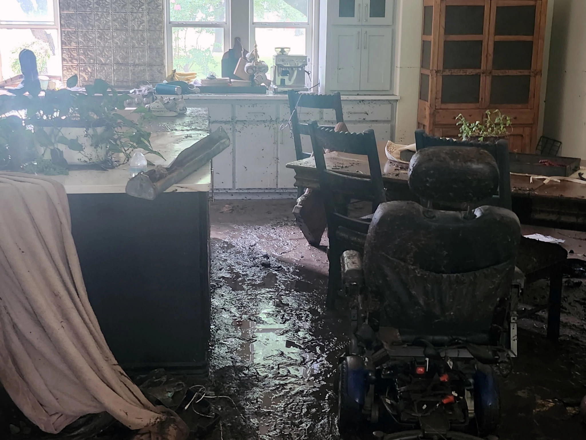 the inside of a home covered in mud from a flood