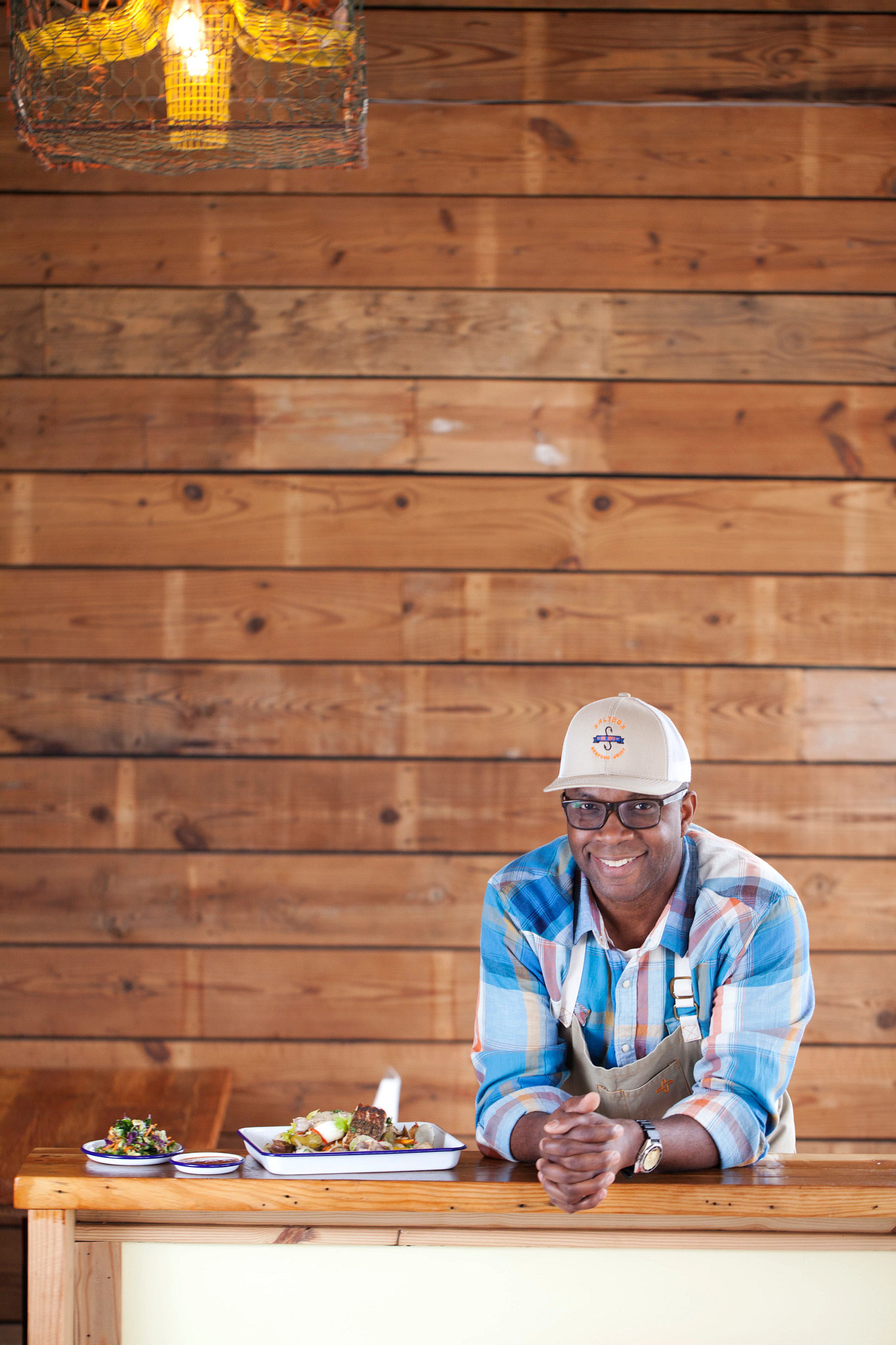 Chef Ricky Moore posing next to food