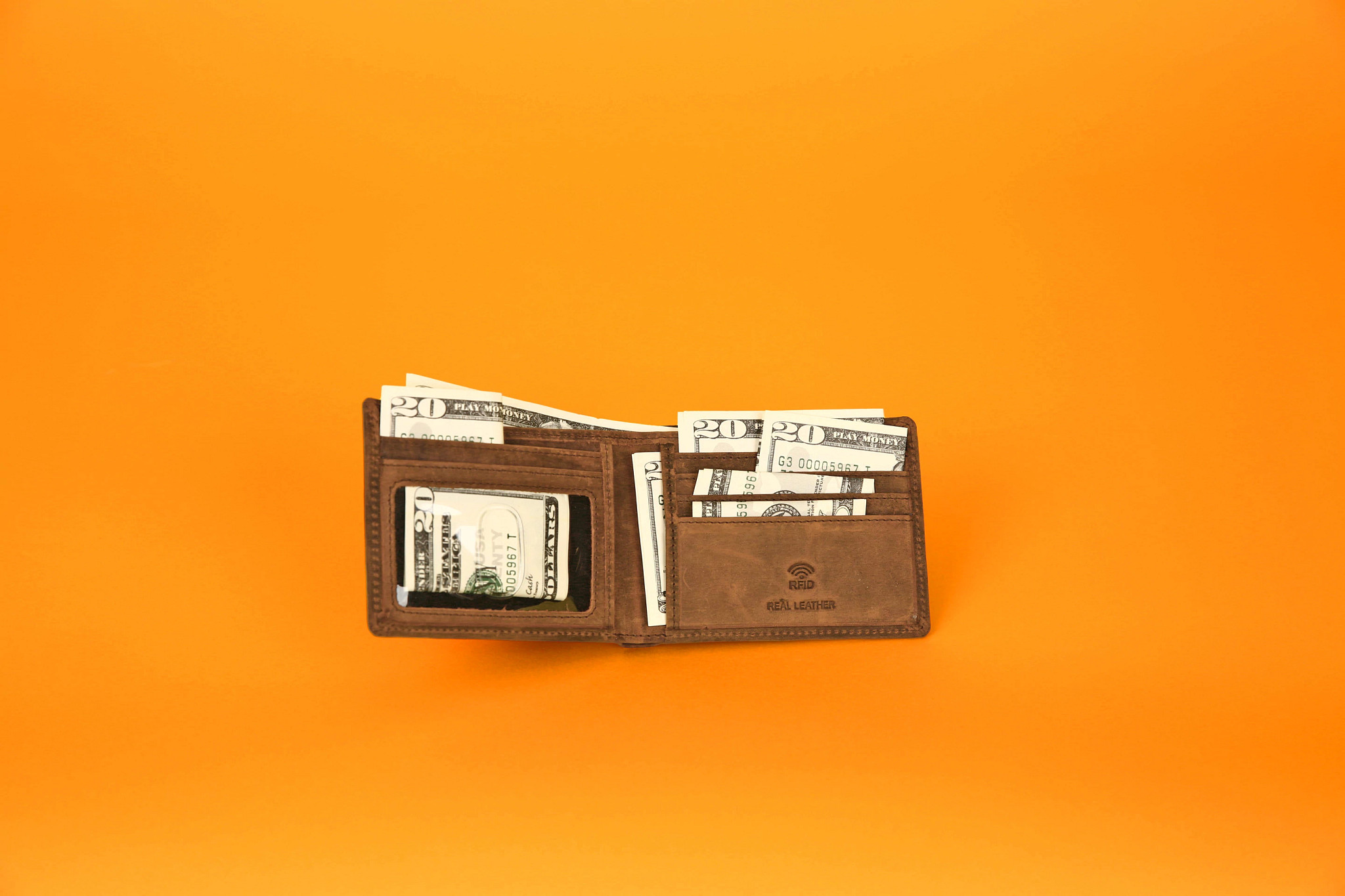 a wallet with twenty dollar bills inside