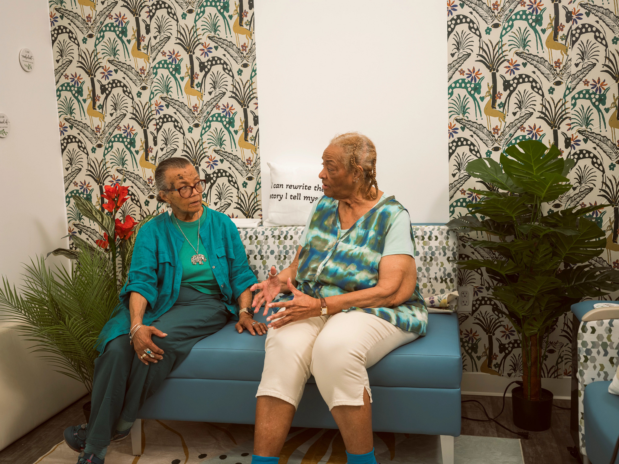 A photo shows grandmother Barbara Allen (on the left) meeting with visitor Janice Hutton on a Friendship Bench at the charity Bread for the City in Washington, D.C.