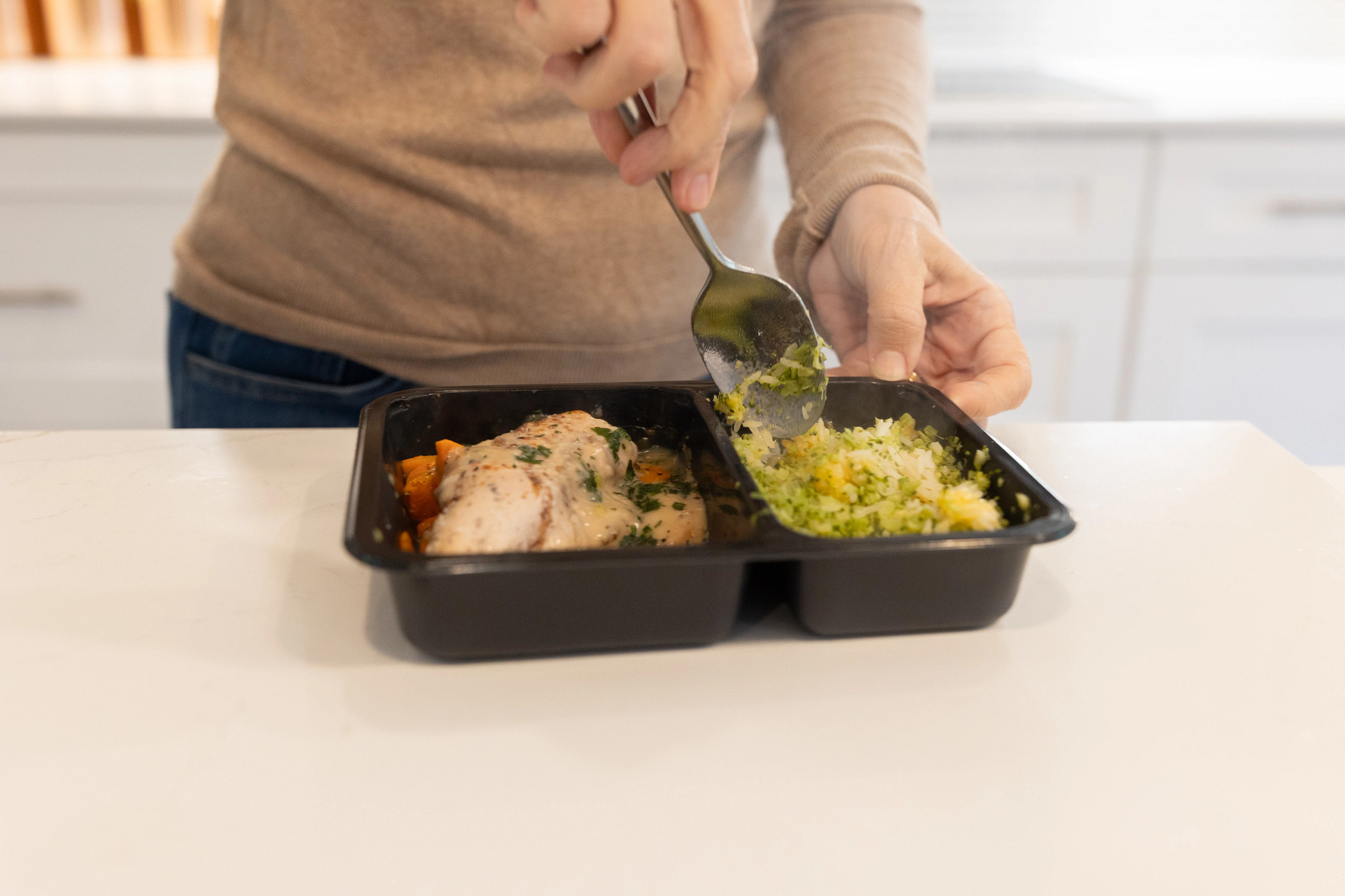 An older adult tester mixing her Tempo prepared meal.