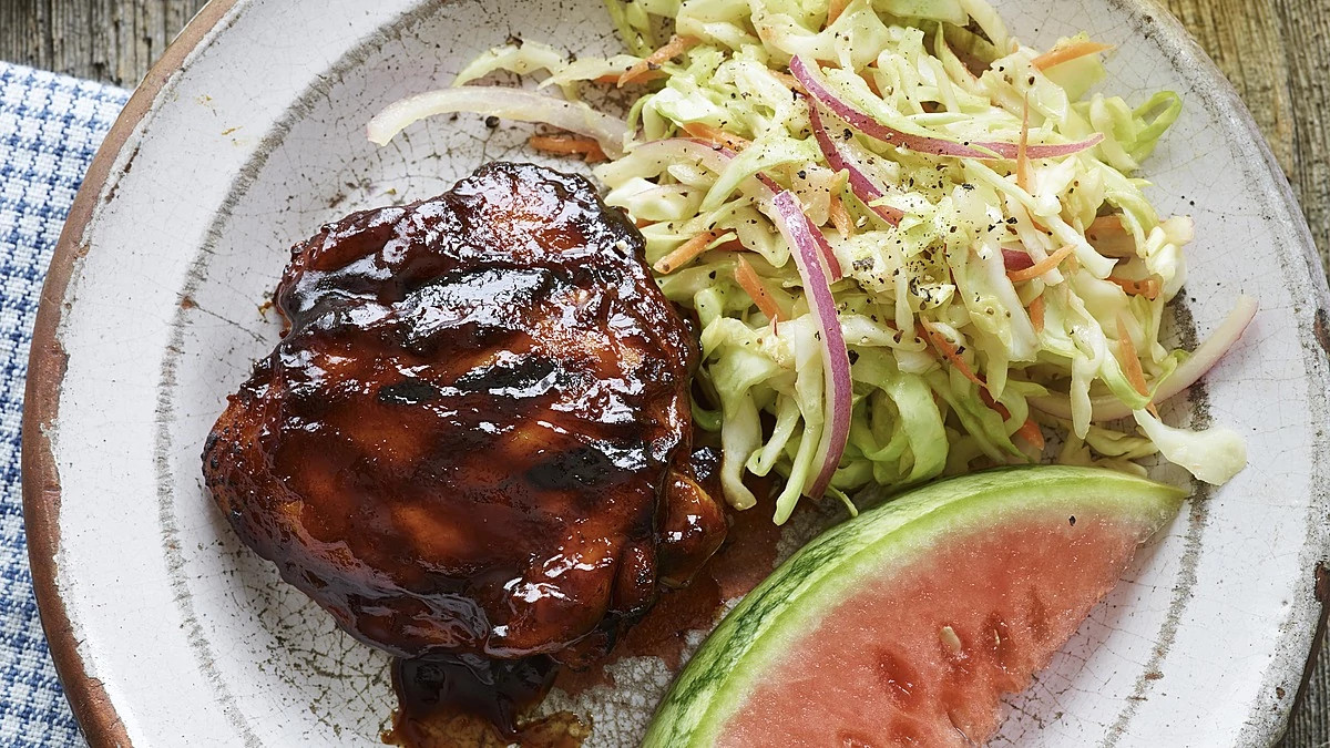 A close-up view of all-American BBQ chicken thighs on a plate