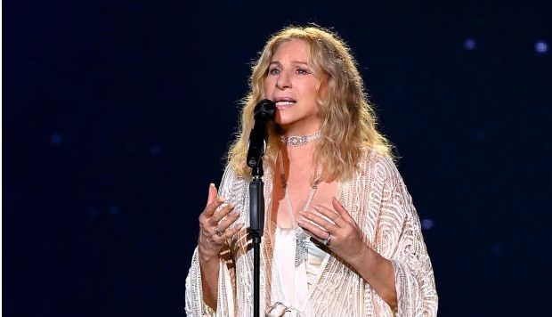 Barbra Streisand performing Barbra Streisand singing into a microphone onstage